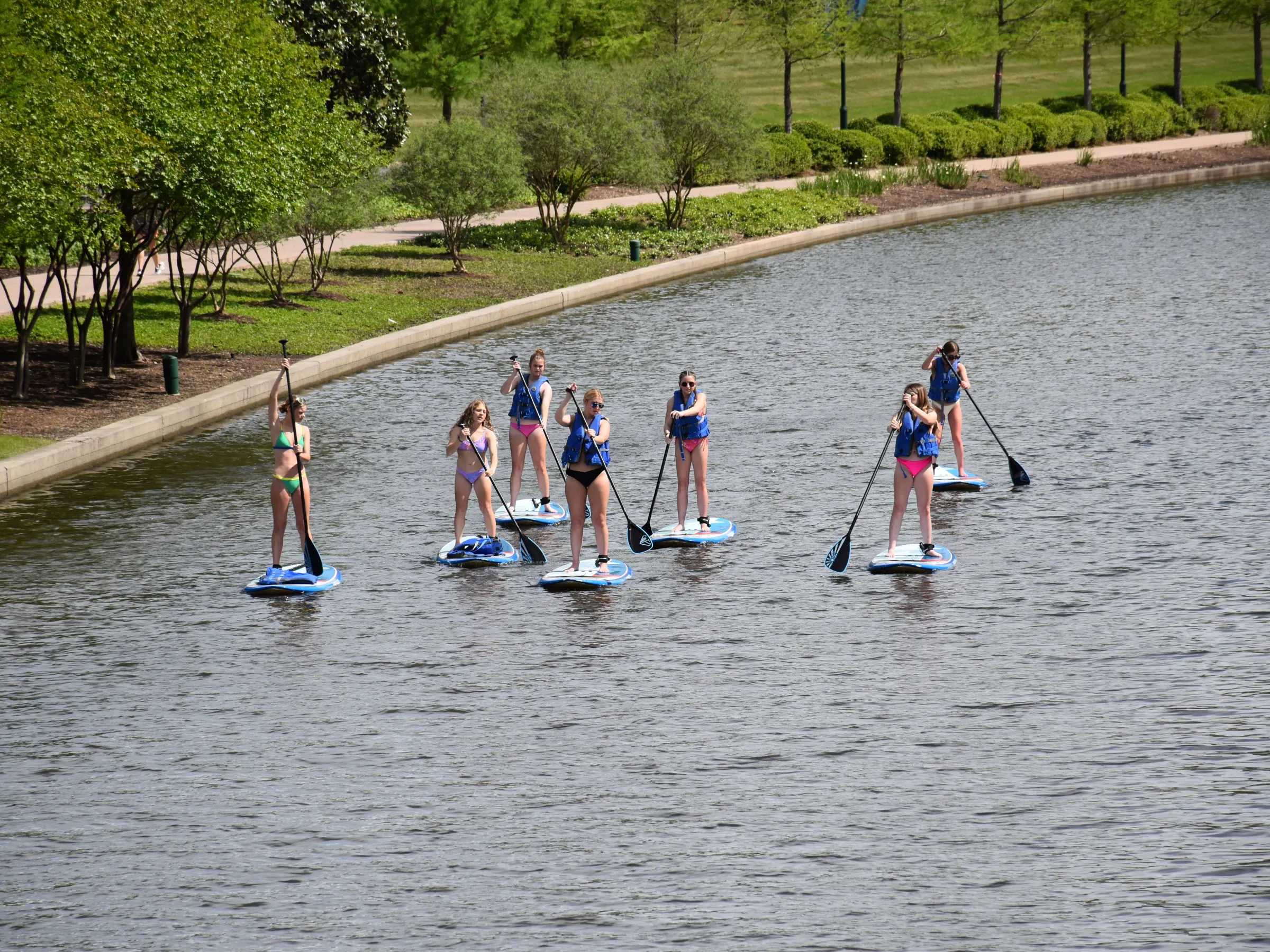 a group of people riding skis on a body of water