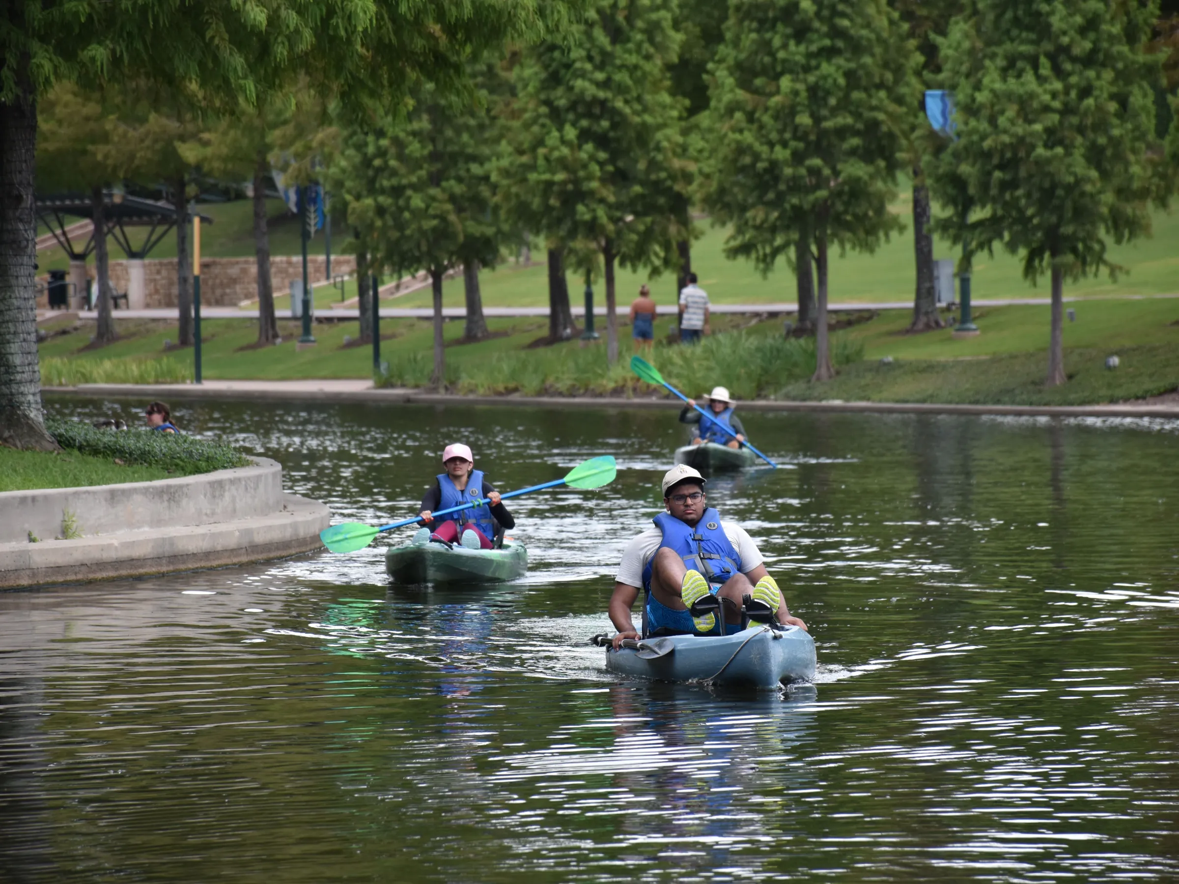 a group of people rowing a boat in the water