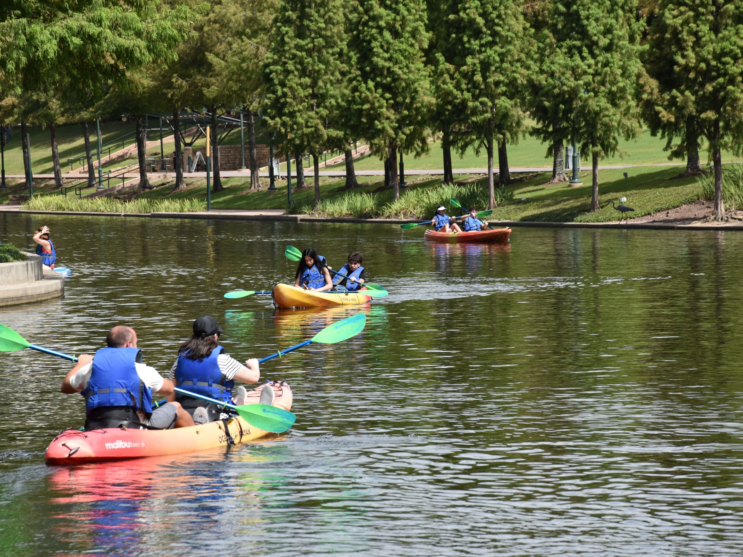 a group of people rowing a boat in the water