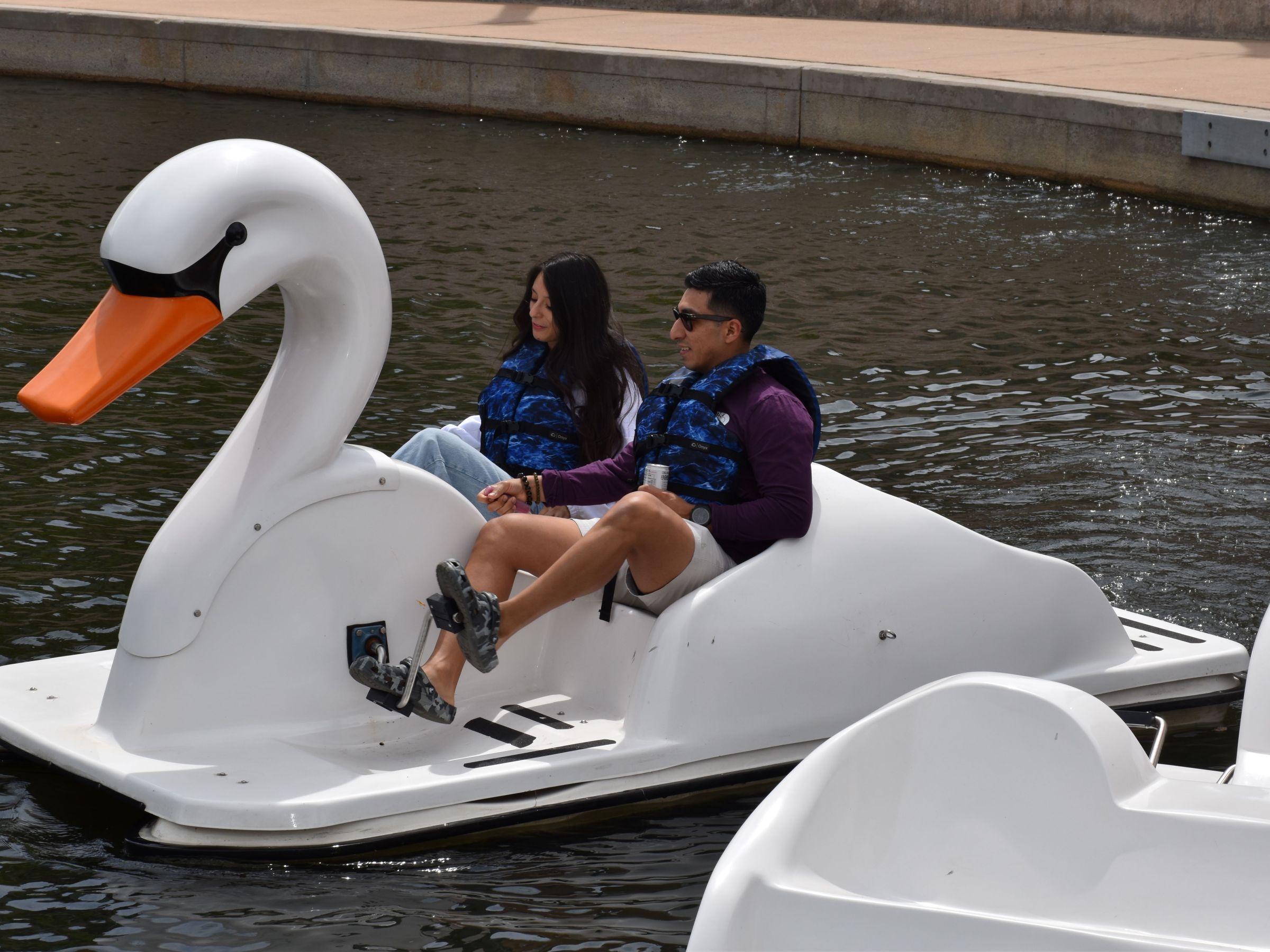 a group of people sitting on a boat in the water